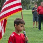 A 10-year-old boy took the stage to sing the national anthem, captivating the audience with his remarkable talent and emotional depth