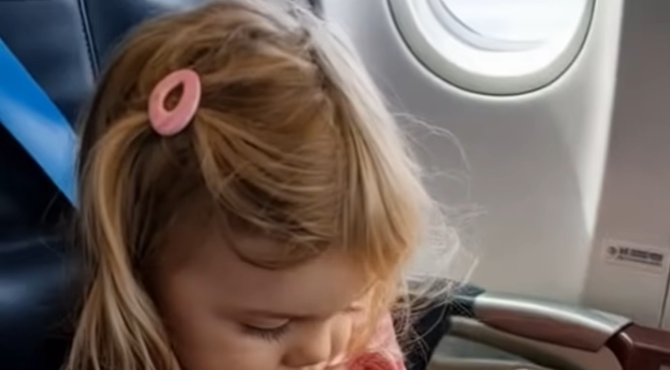 I was flying with my 5-year-old, Ella, and she was happily watching something on her iPad with headphones on.